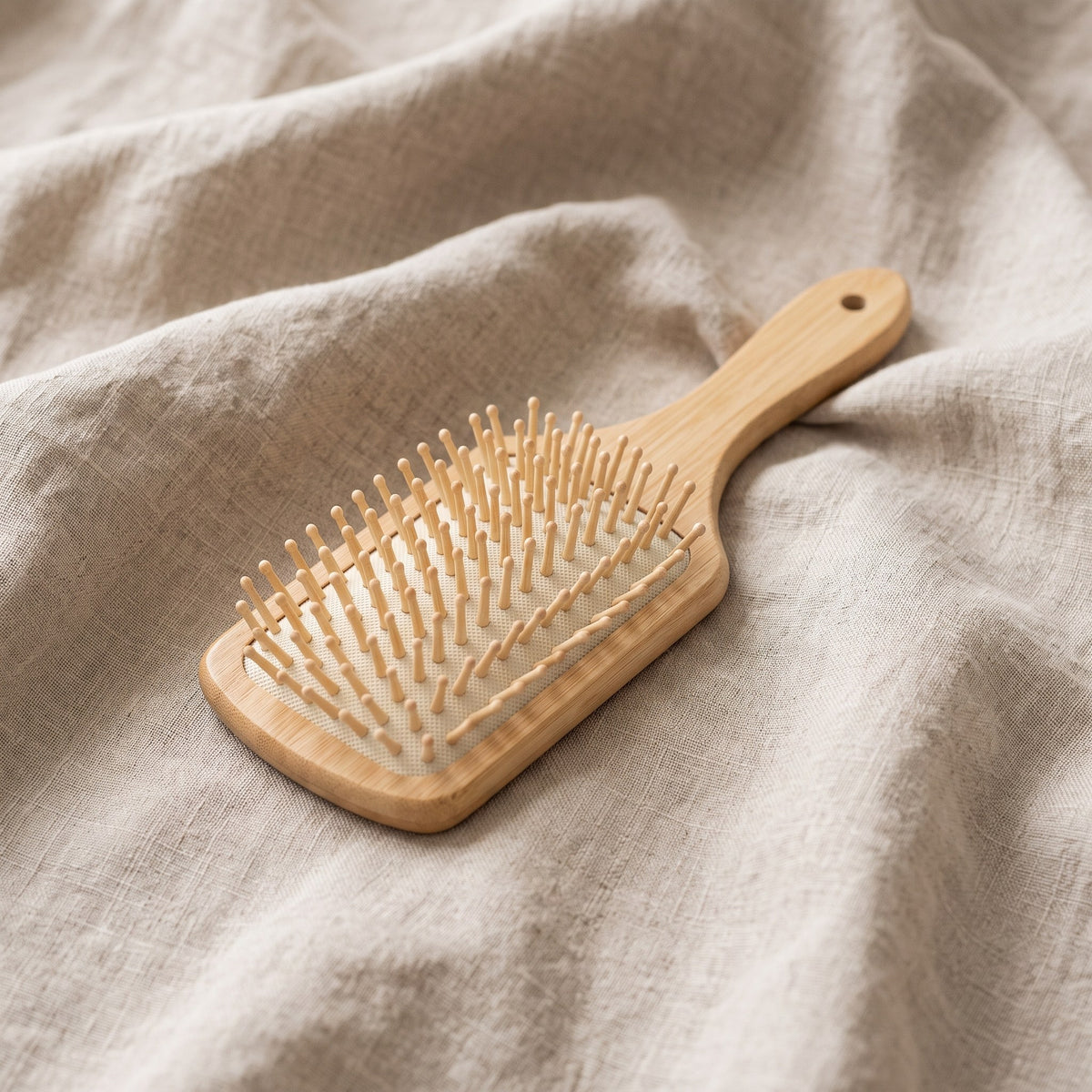 Bamboo paddle brush on beige linen
