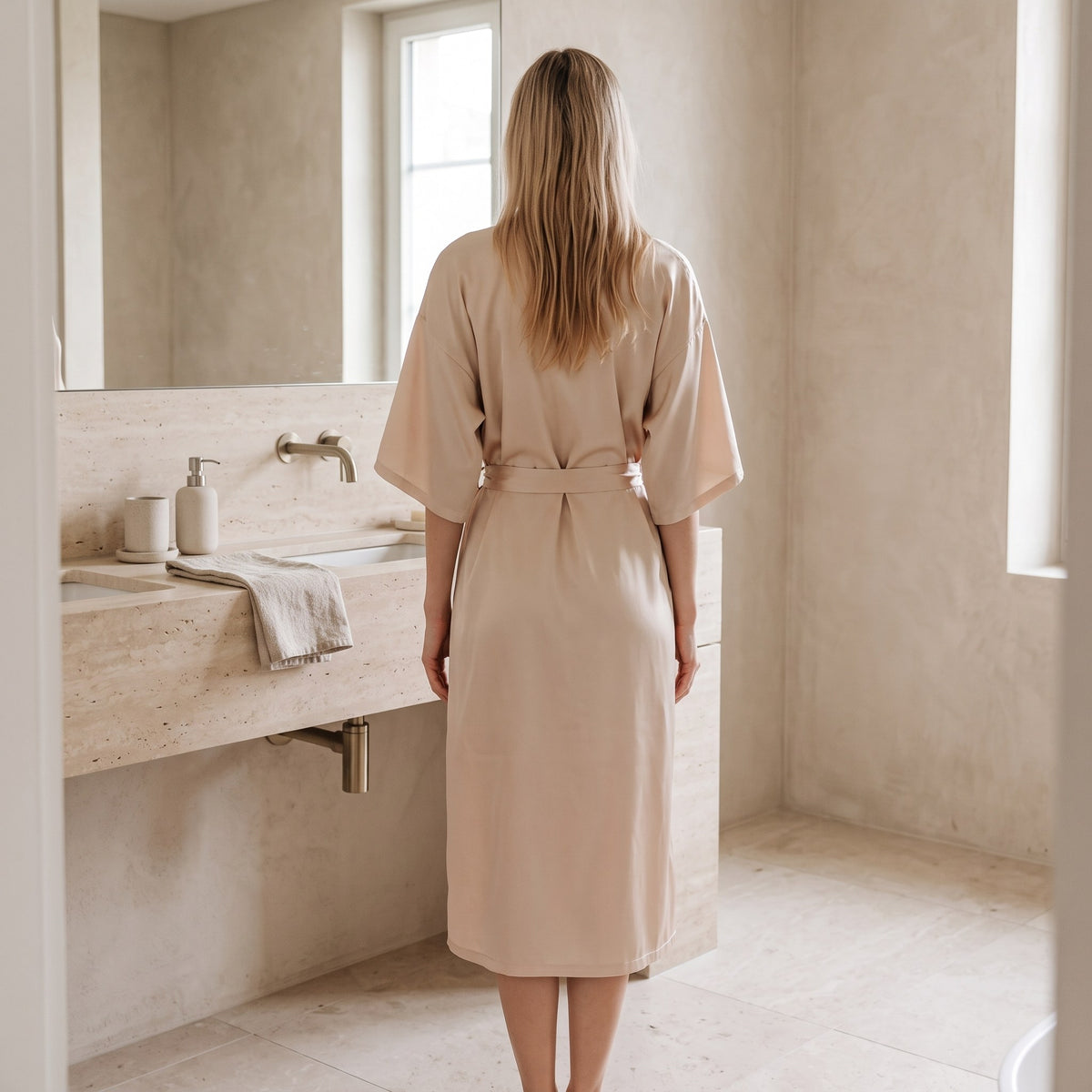 Woman in the champagne satin kimono robe in a bright bathroom #champagne