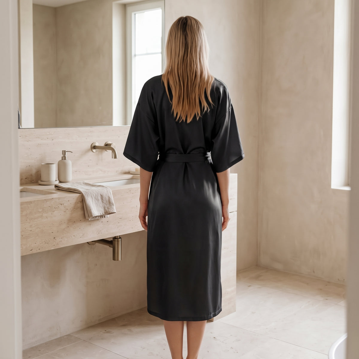 Woman in the black satin kimono robe in a bright bathroom #black
